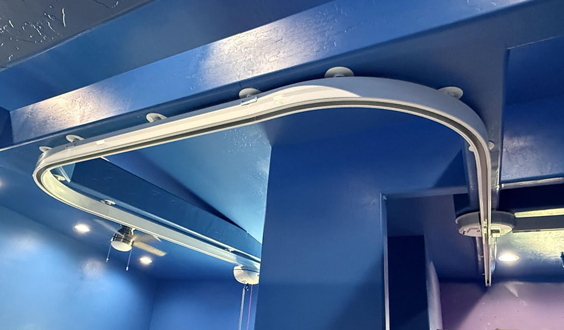 Ceiling Lift Custom ceiling lift track with exposed cord installed in a residential care setting.
